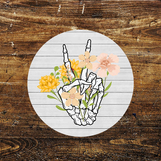 Skeleton Hand Holding Yellow Flowers Circle Metal Sign